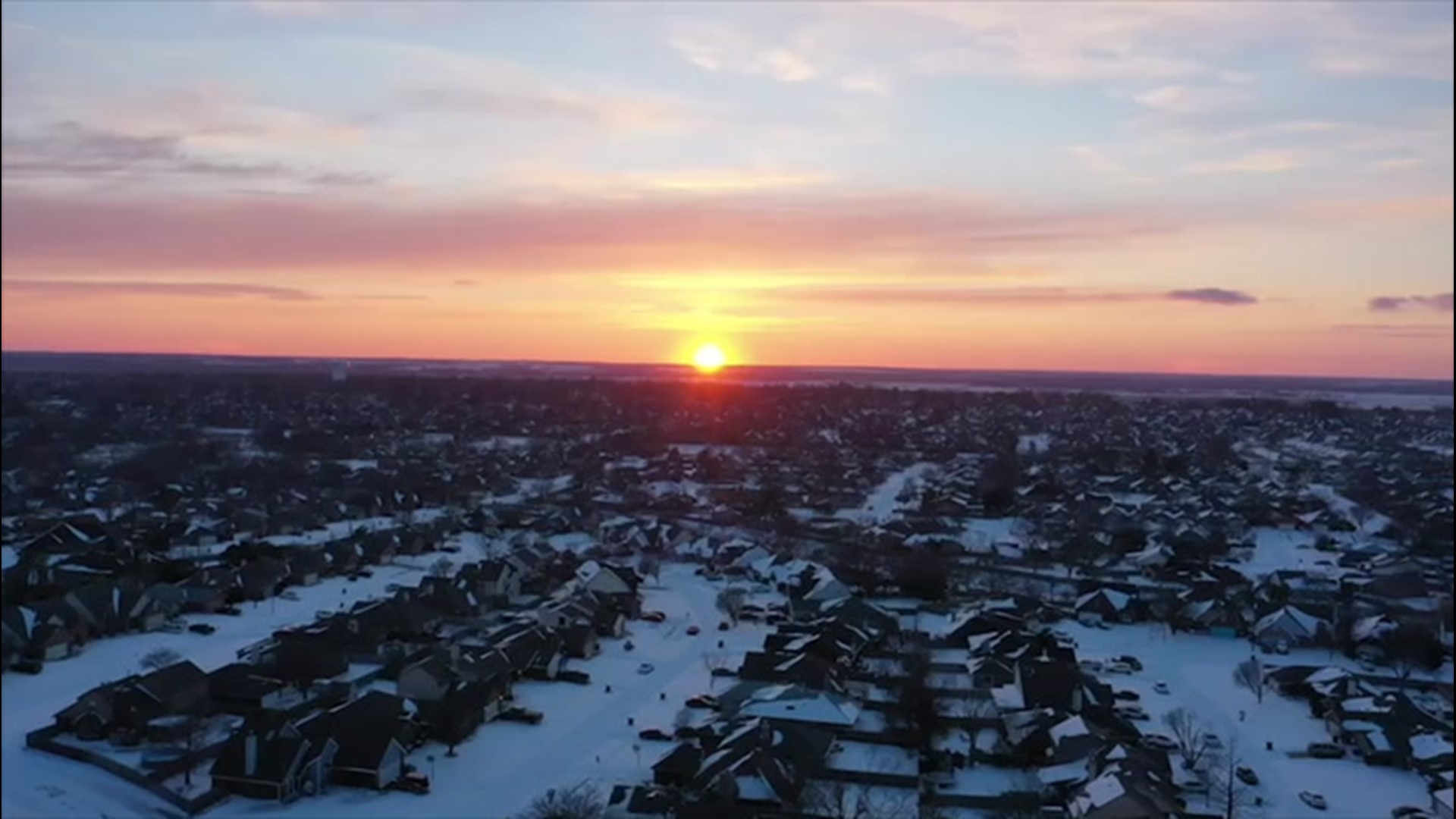 Aerial video from Extreme Meteorologist Reed Timmer on Feb. 15 showed the sun dropping over the horizon beyond a snow-covered Norman, Oklahoma.