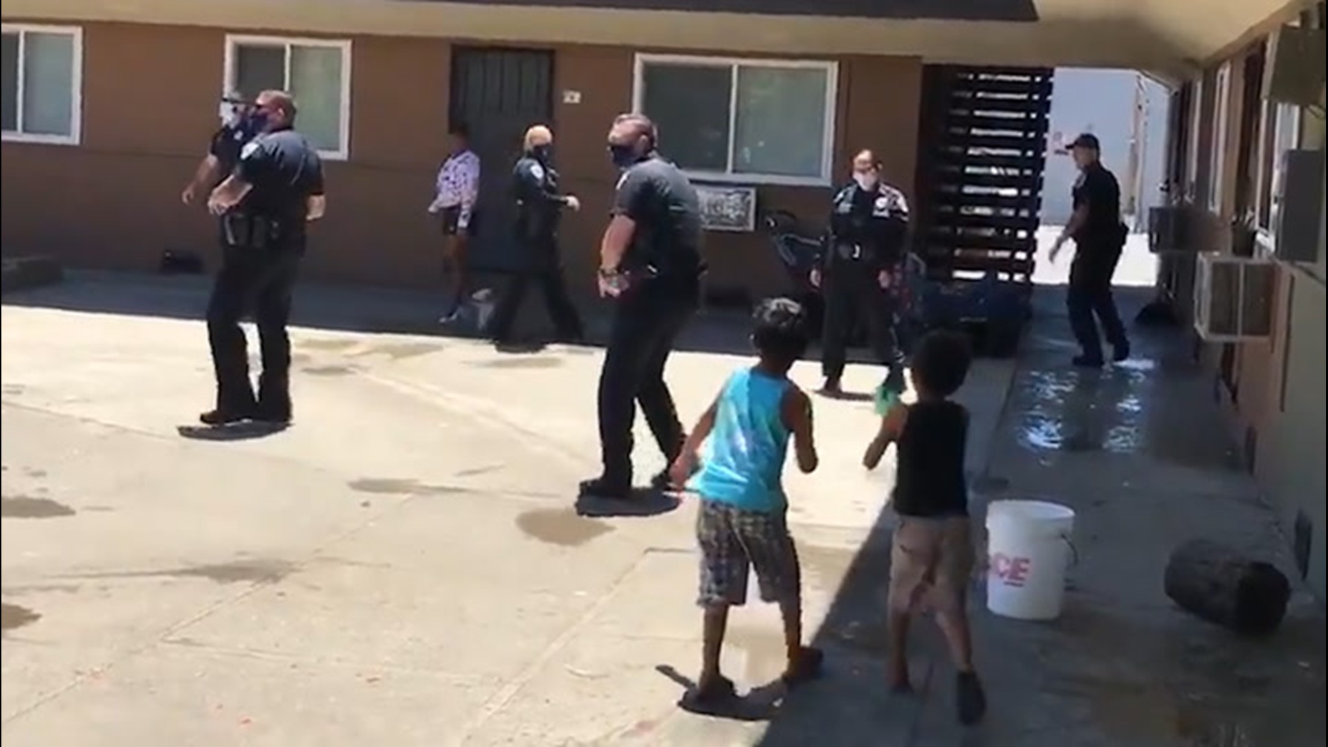 Police officers in Fairfield, California, set up a water fight for kids playing outside to stay cool on June 23. The pools were closed due to COVID-19.