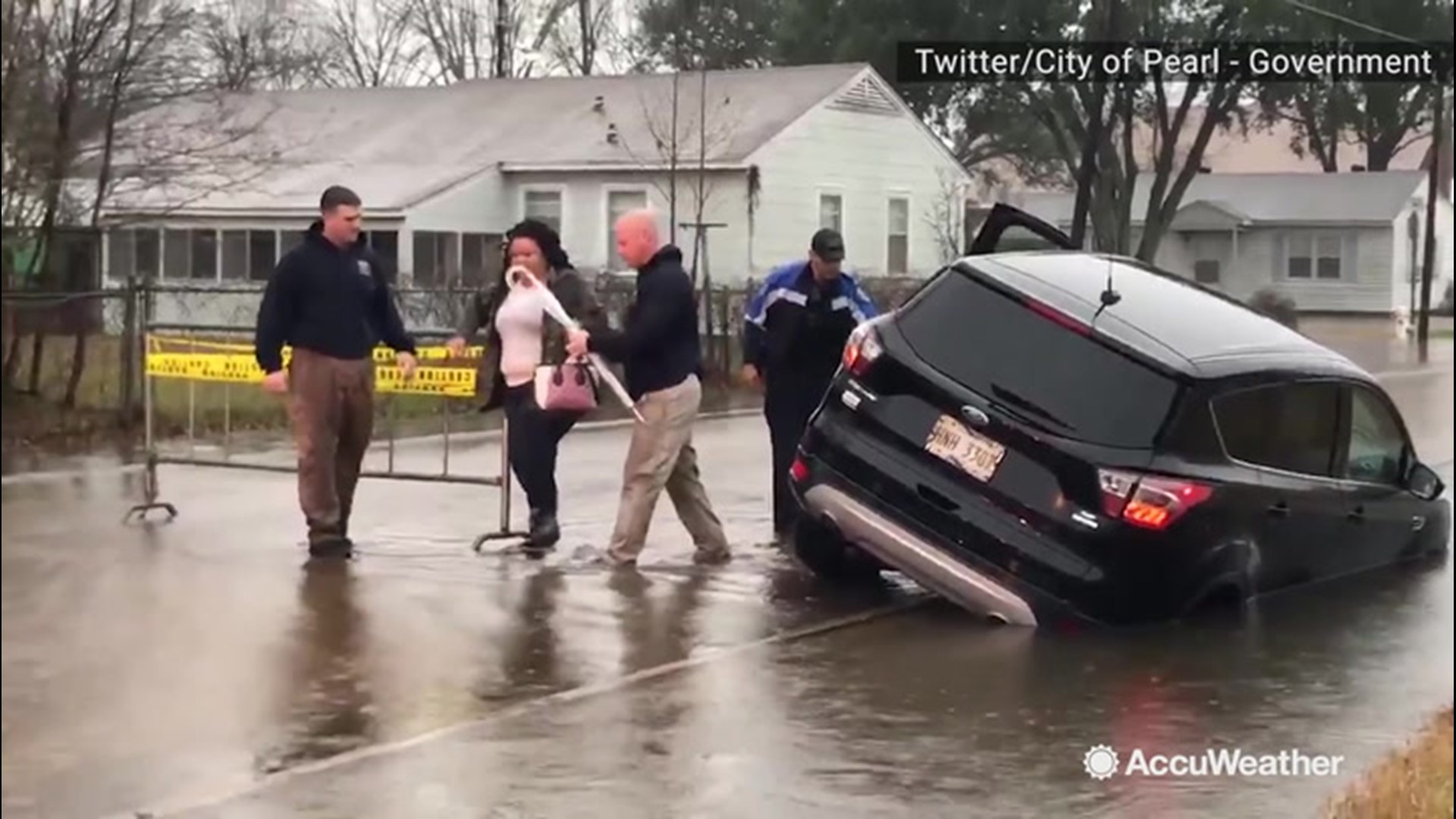 This driver in Pearl, Mississippi, found herself stuck in floodwaters after driving around barricades on Jan. 14. Fortunately, she was not hurt.