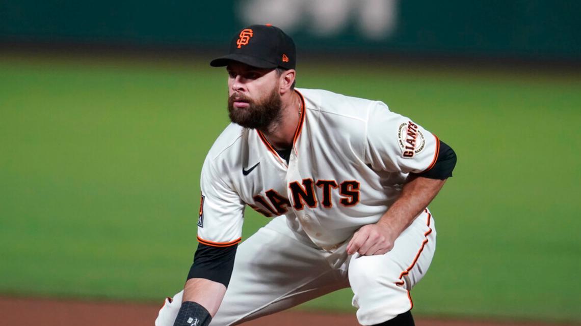 FOR SPORTS - Texas' Brandon Belt bobbles a throw at first base