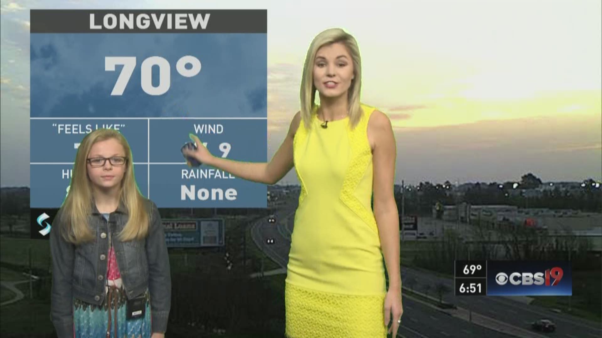 Karsyn Williamson from Troup Middle School helps Ashley Kramlich give this morning's Weather Kid Report.
