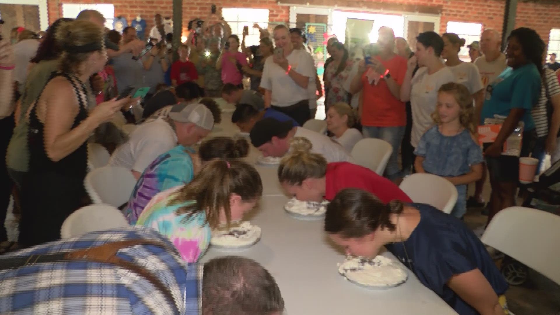 Highlights of the pie eating contest where contestants paid $10 to try to be the fastest to eat a whole Chocolate Meringue pie without using their hands. A messy good time to raise money for the Blue Santa program. The winners received a free Whataburger