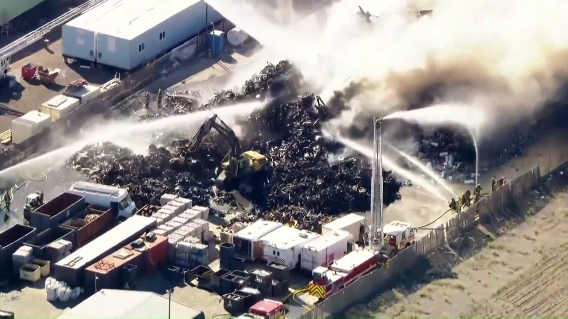 Fire at Californian scrap metal yard fills sky with thick plumes of ...